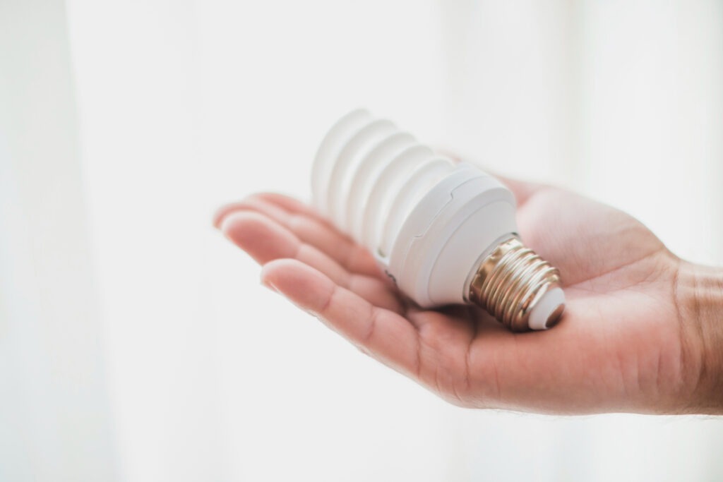 compact-fluorescent-light-bulb-hand-5901559