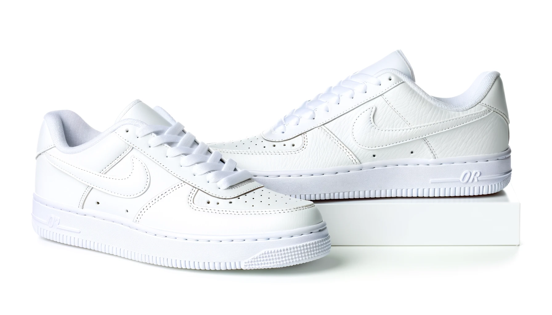 dall%c2%b7e-2024-02-16-16-25-50-a-pair-of-low-top-retro-style-sneakers-in-all-white-including-white-laces-on-a-white-background-the-sneakers-have-a-smooth-leather-upper-with-perfo-4288757