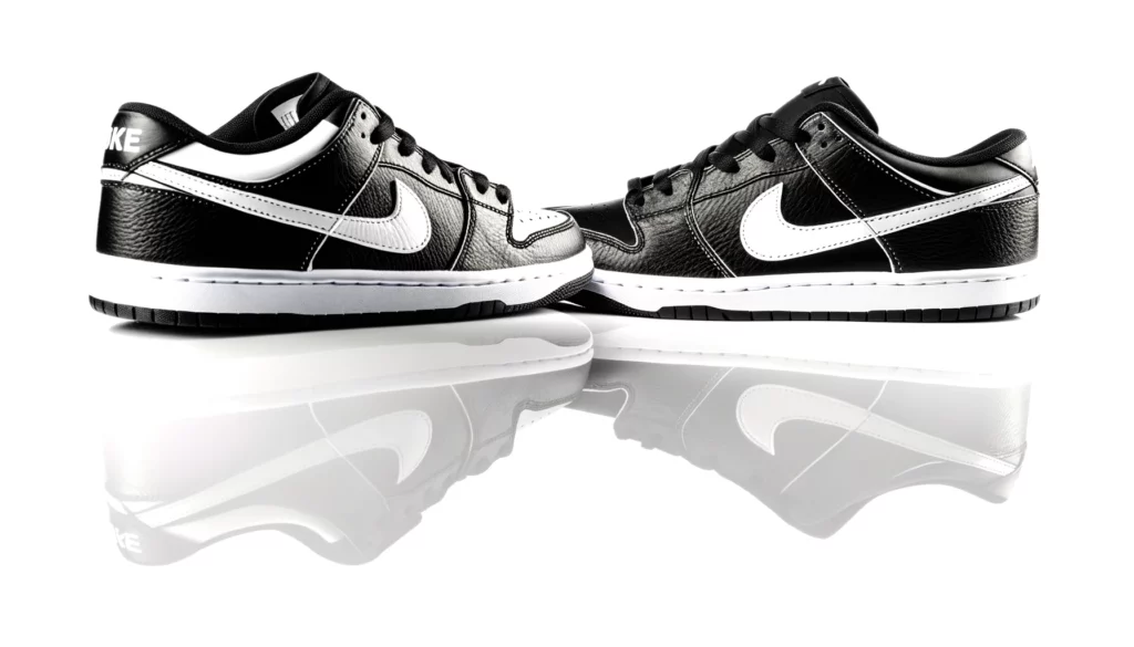 dall%c2%b7e-2024-02-17-21-09-41-a-pair-of-black-and-white-low-top-sneakers-on-a-plain-white-background-the-shoes-are-placed-side-by-side-with-a-slight-overlap-facing-slightly-towar-3557151