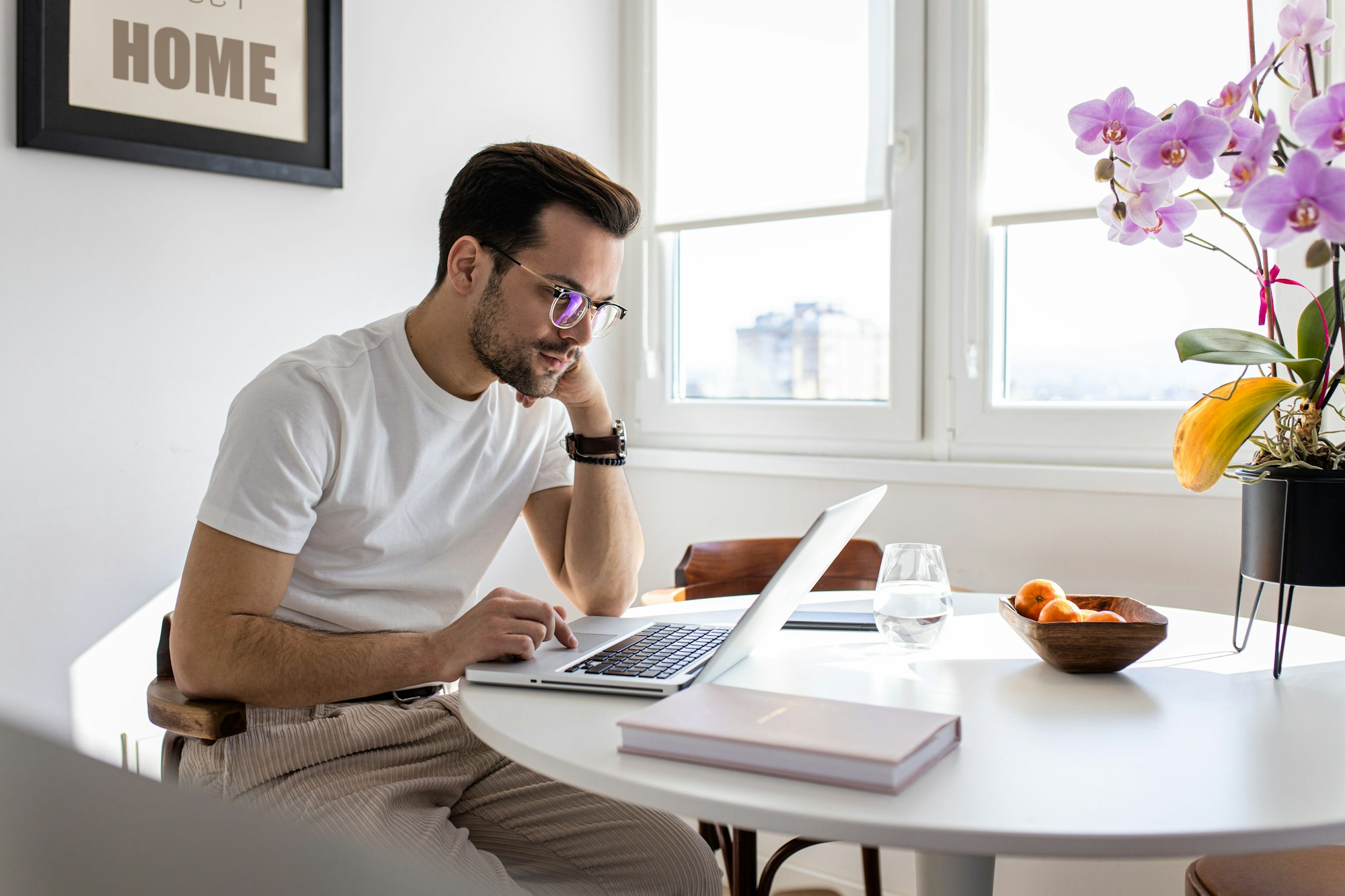 Man working at home using laptop.